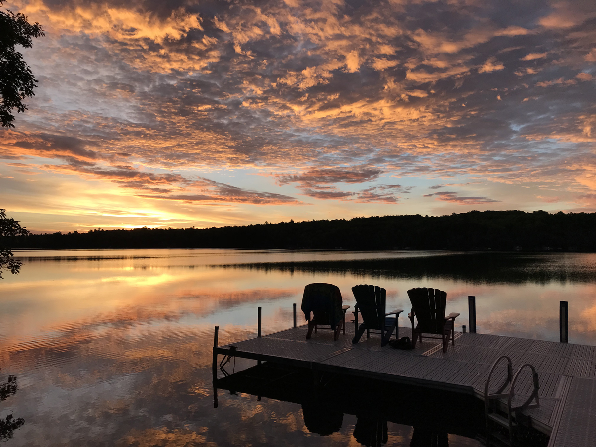 Sunset over water with dock in foreground