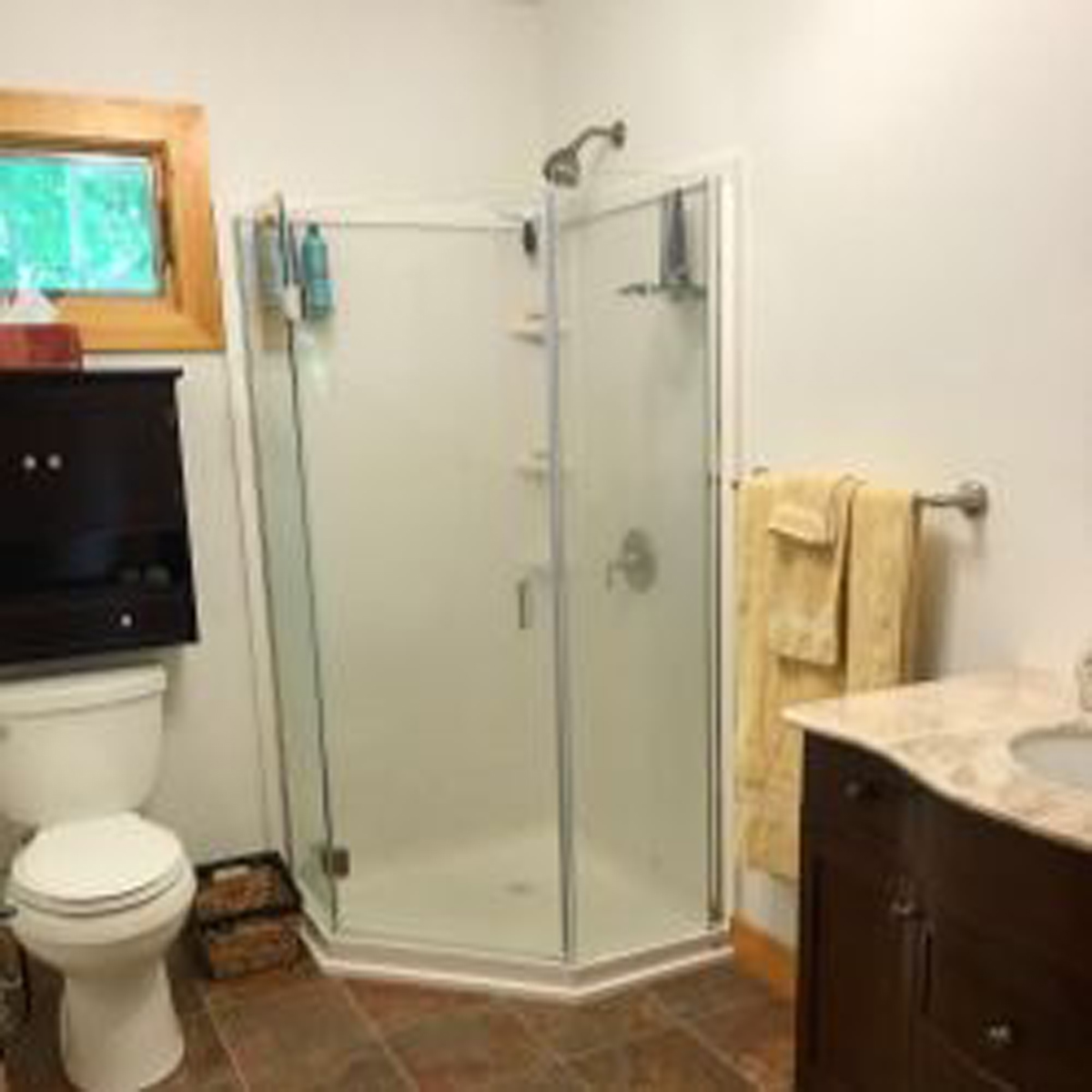 First bathroom with standup shower, toilet, sink