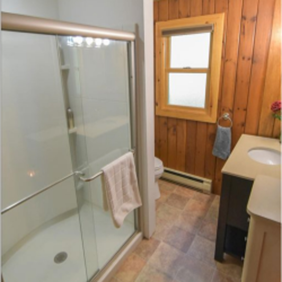 Second bathroom with full size, standup shower, toilet, sink